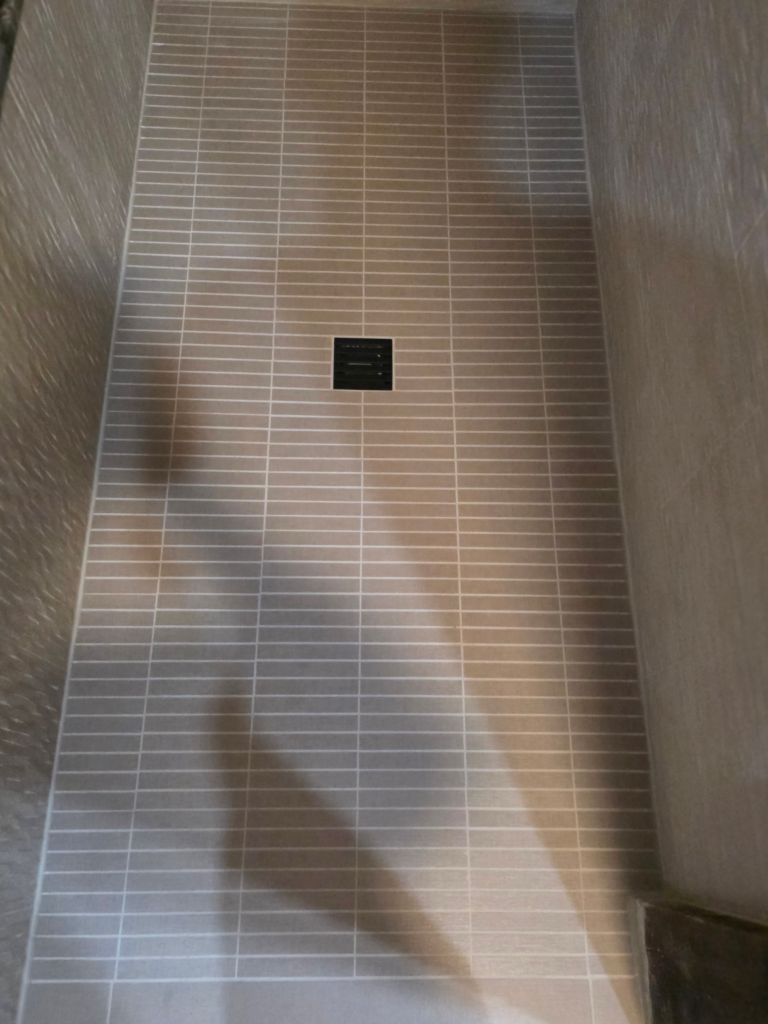 Lake George New York shower floor rectangle tile custom install white grout
